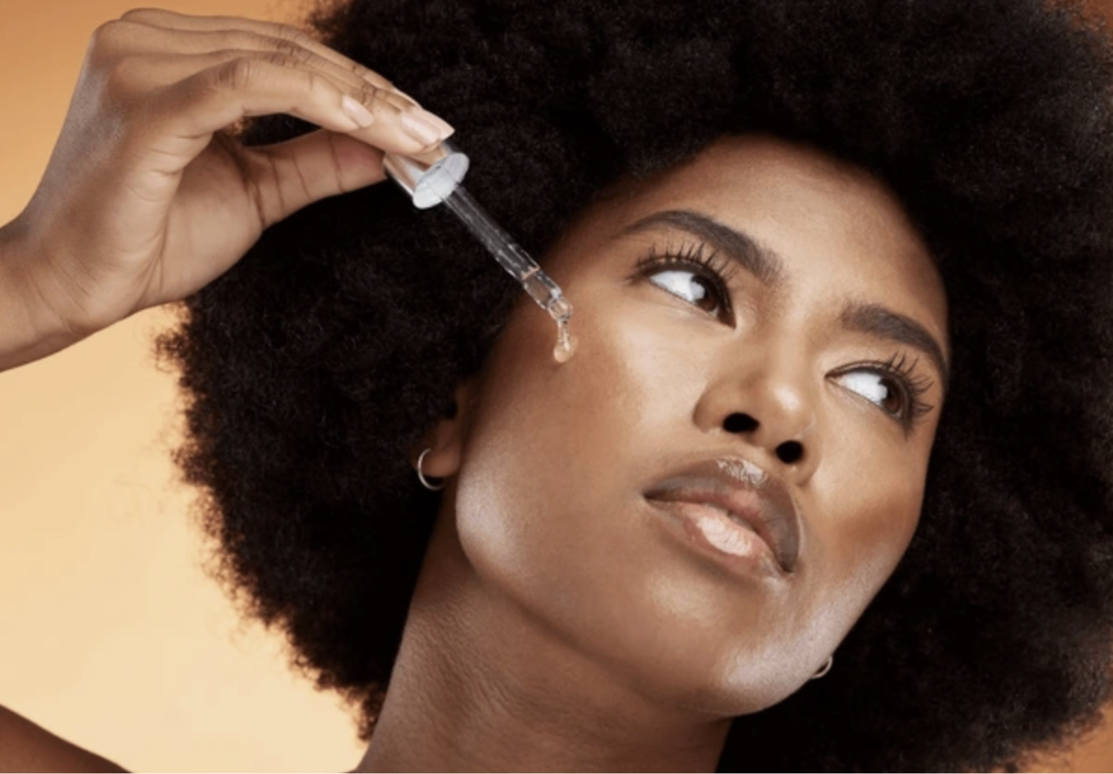 Portrait beauty photography — woman applying serum